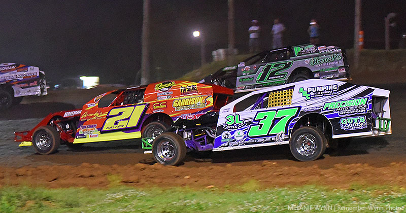 Jackie Dalton (21) battles with Wesley Long (37) and Juston Comer (112) in Reliable Chevrolet USRA B-Mod action at the Springfield Raceway.